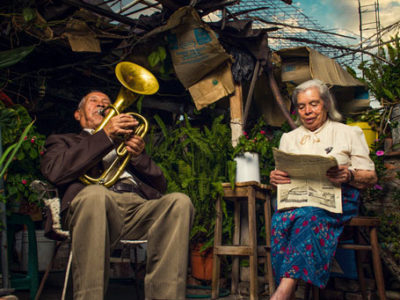Couple in their garden, reading and making music, Mexico