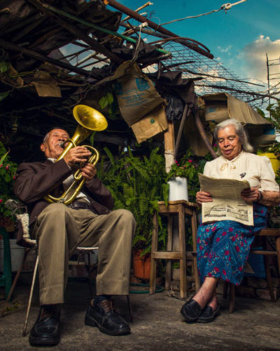 Couple in their garden, reading and making music, Mexico